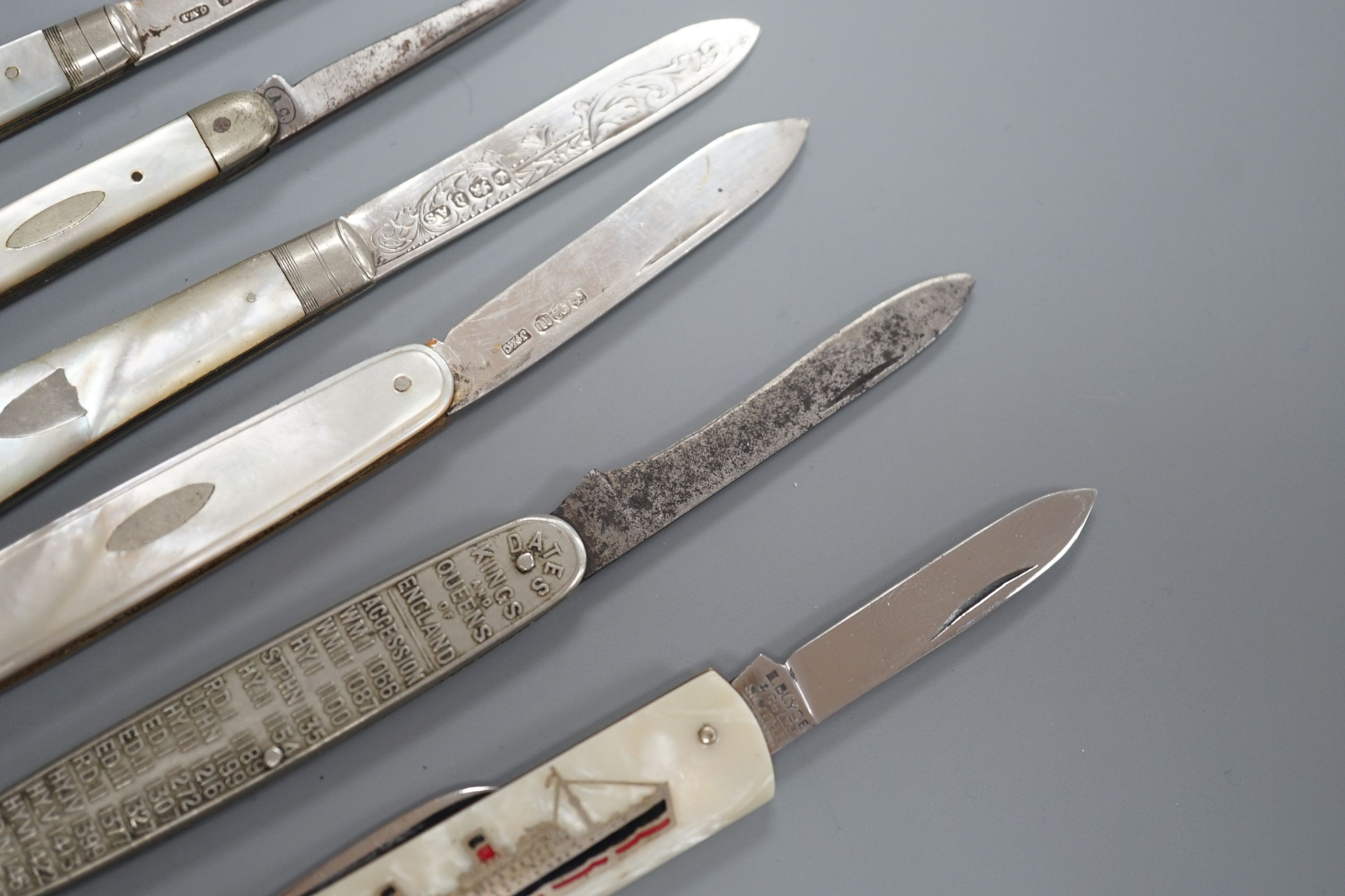 Three assorted mother of pearl mounted silver bladed fruit knives, one other penknife and two commemorative pocket knives.